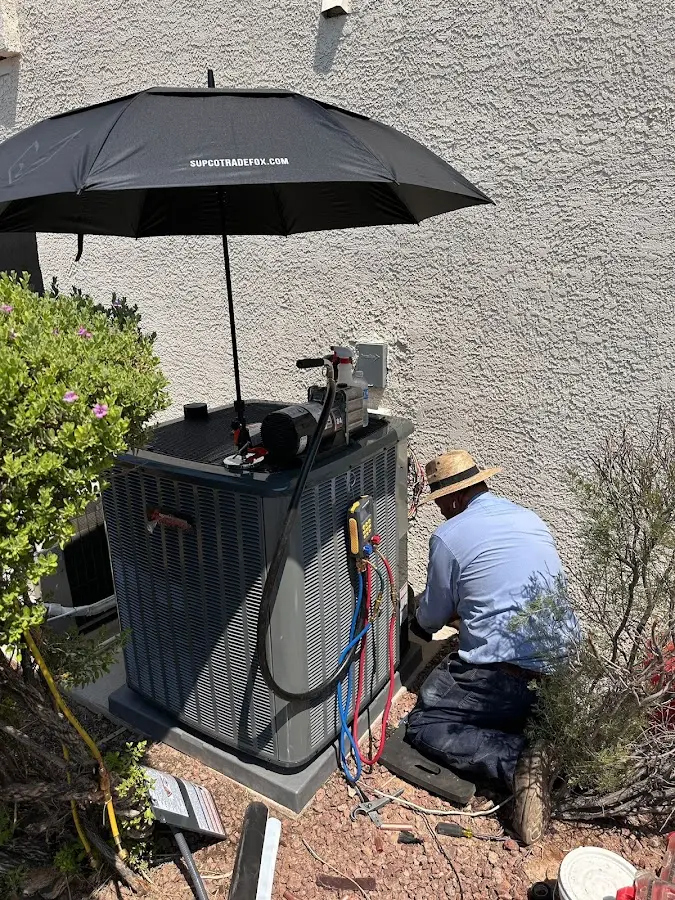 HVAC technician performing outdoor AC maintenance in Sammamish